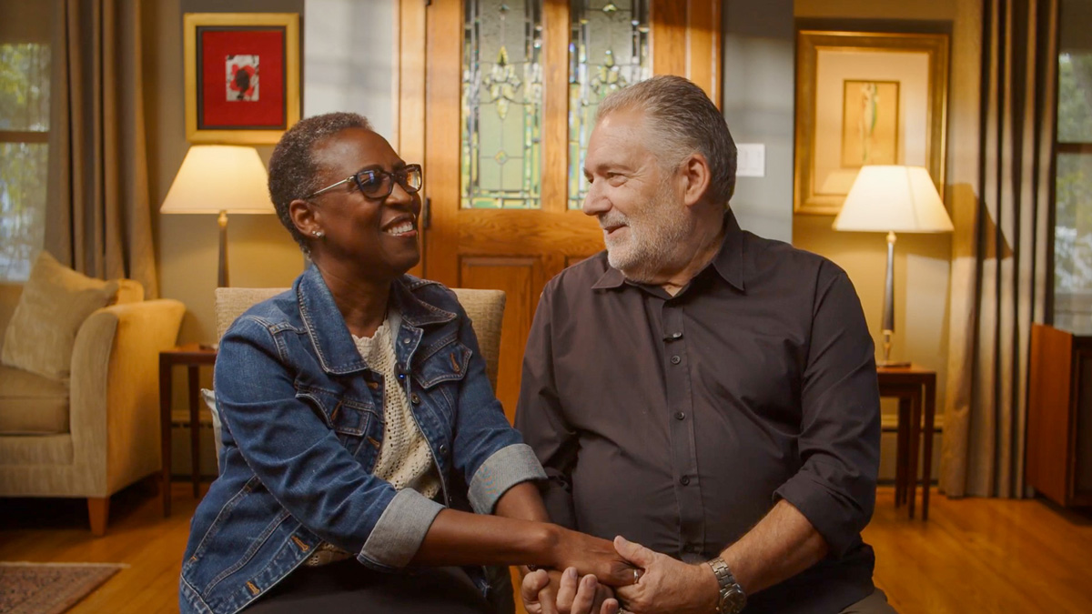 Chris and Carlene Ellerman smiling at each other during a filmed interview